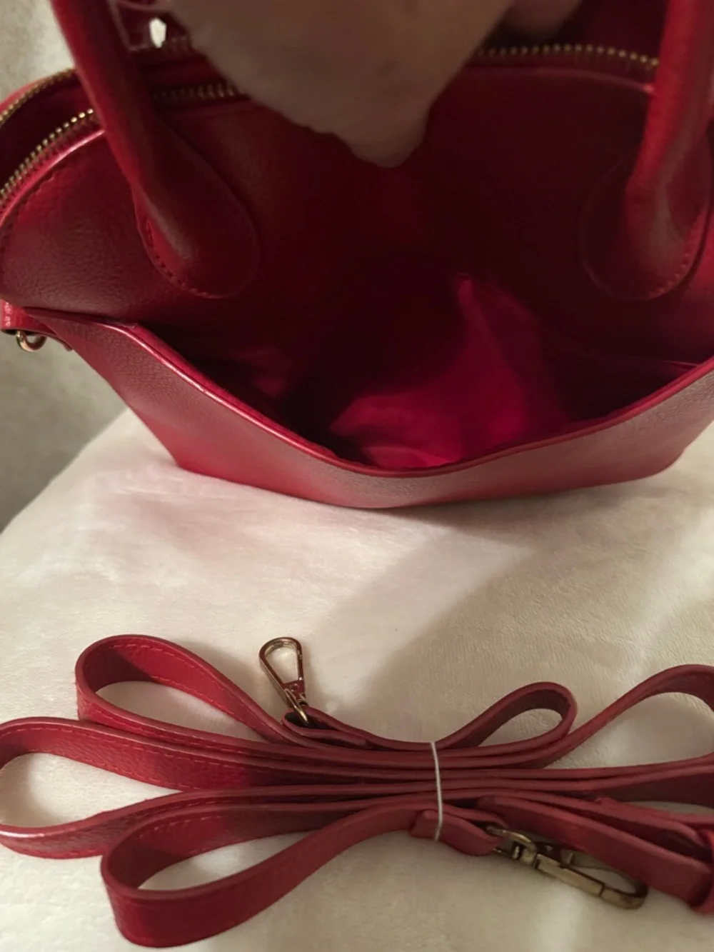 bebe Red Pebbled Fabiola Leather Satchel with Gold Logo Accent with strap.